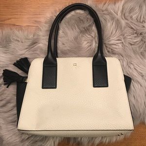 Cream and black Kate Spade purse with tassels